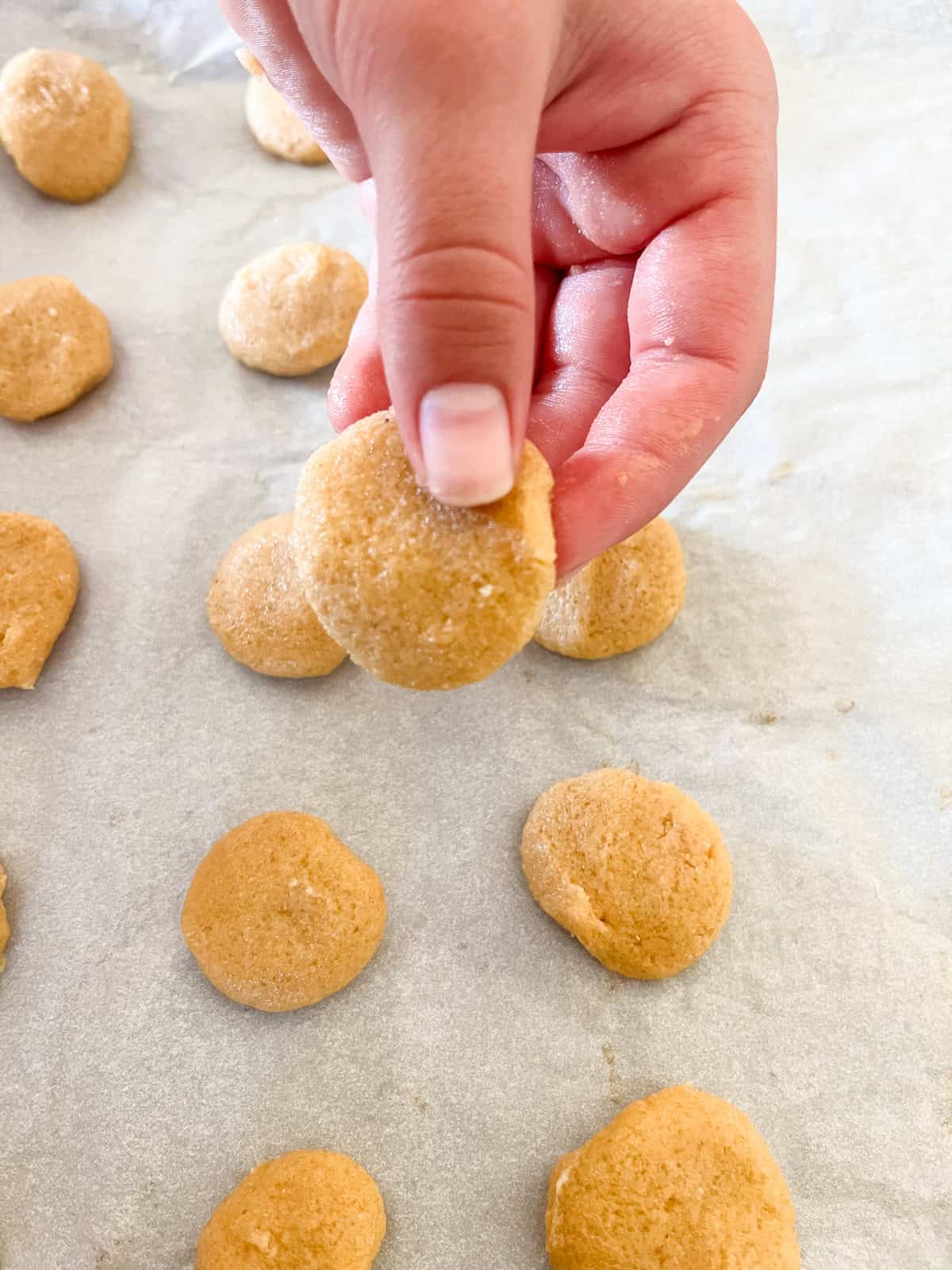 Shaping vanilla wafer dough into small circles.
