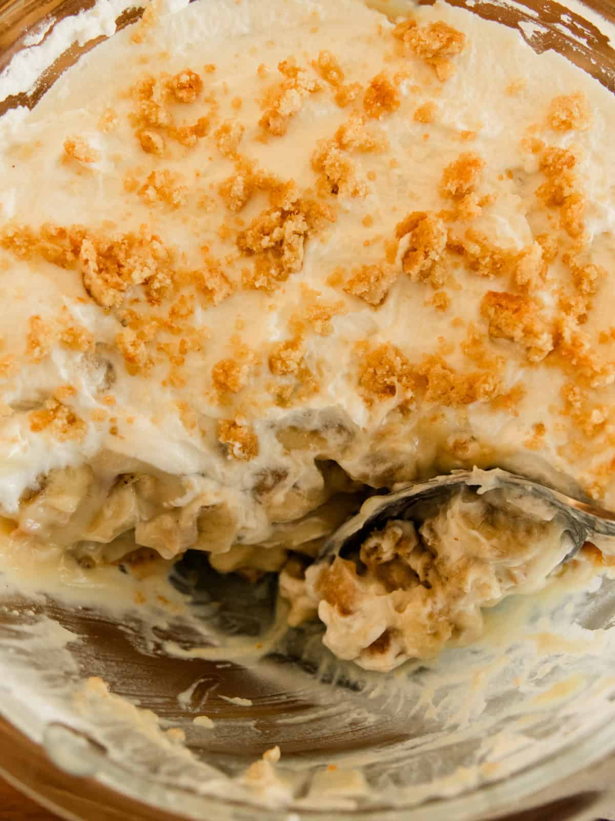 Scooping a serving of banana pudding out of the bowl.