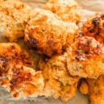 Cheddar biscuits with freshly milled flour stacked on a plate.