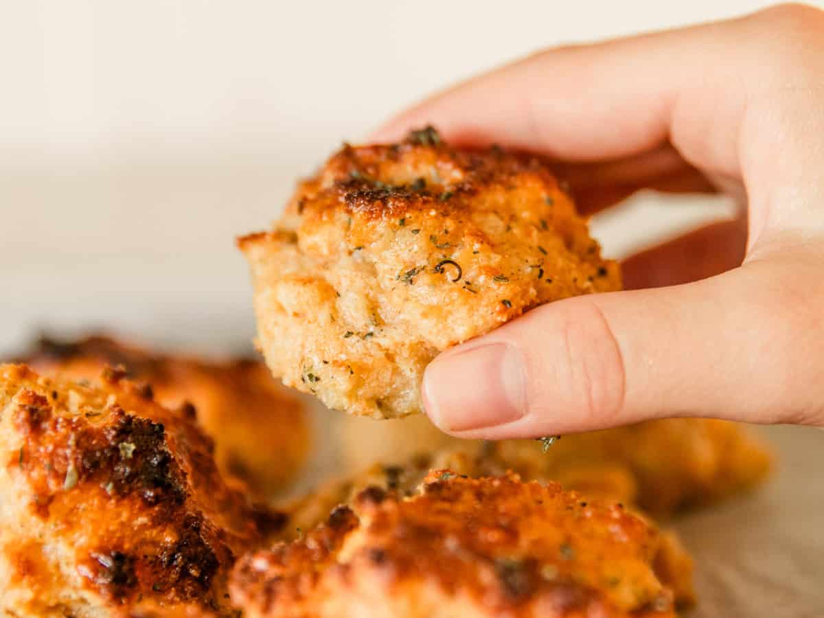 Holding up a cheddar biscuit with freshly milled flour.
