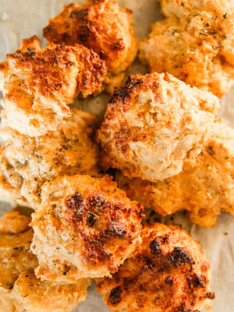 Cheddar biscuits stacked in a pile.