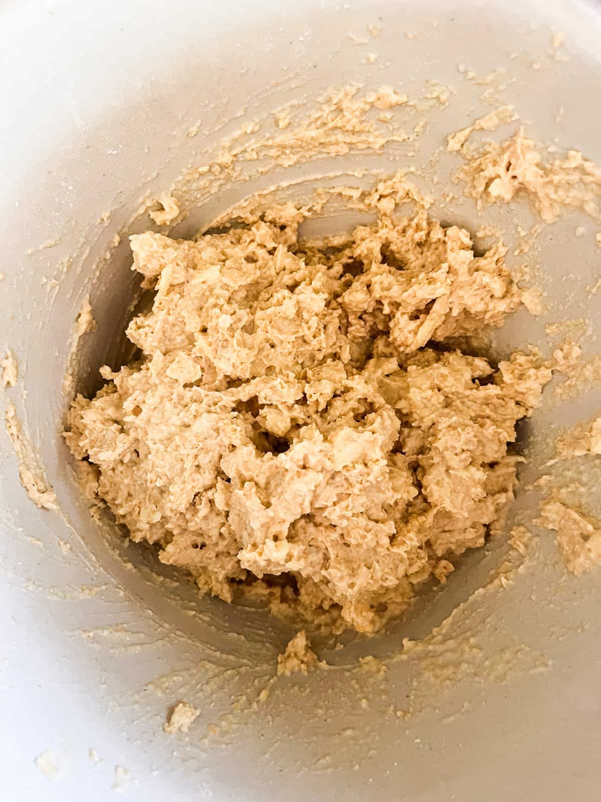 Cheddar biscuit dough fully combined in a mixing bowl.