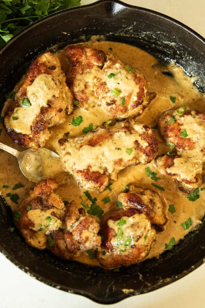 Creamy garlic chicken in a cast iron skillet.
