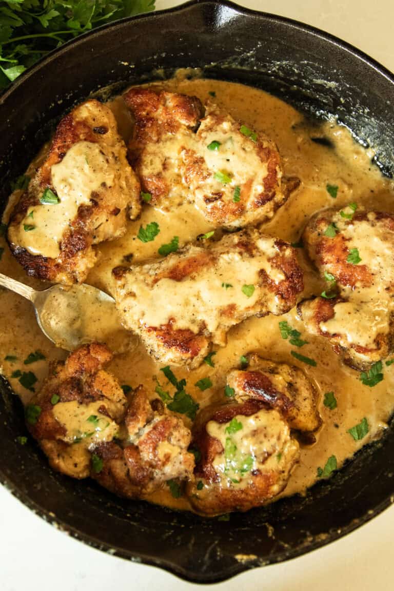 Creamy garlic chicken in a cast iron skillet.