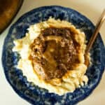 Venison salisbury steak on a bed of mashed potatoes.