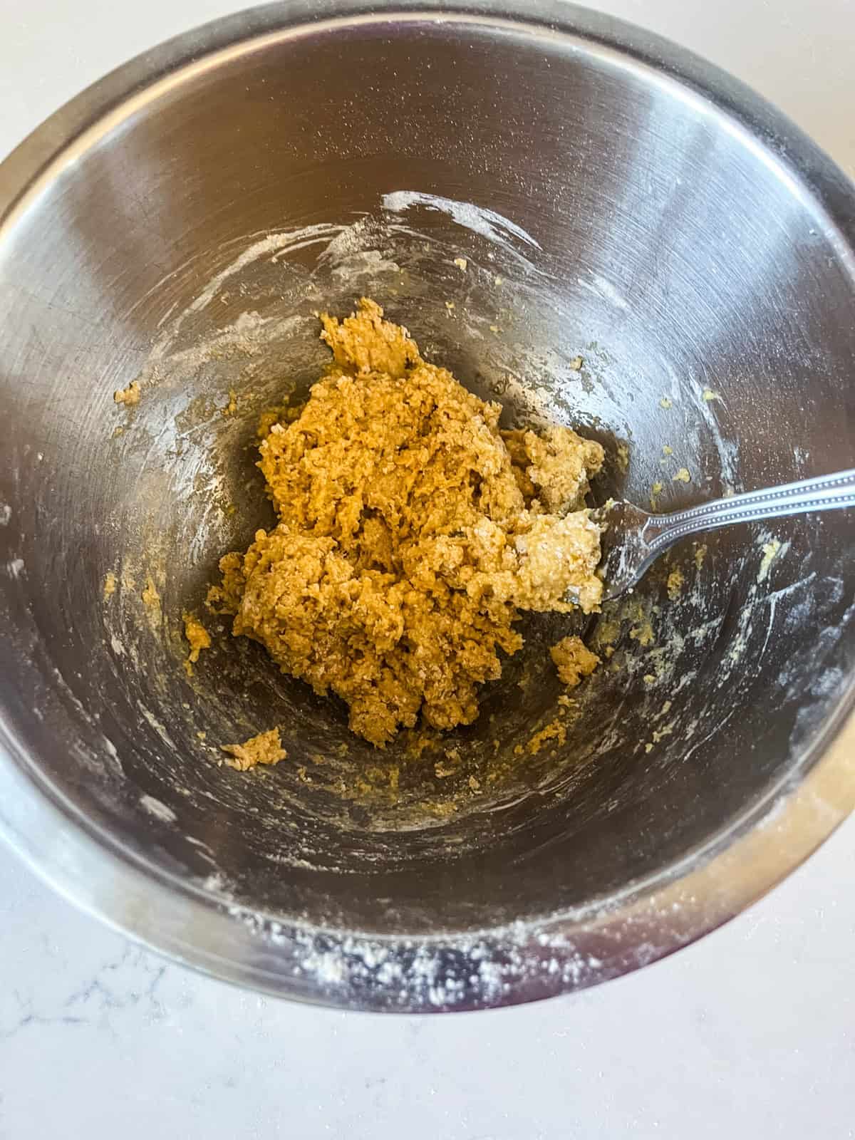 Mixing dough for cheese balls.