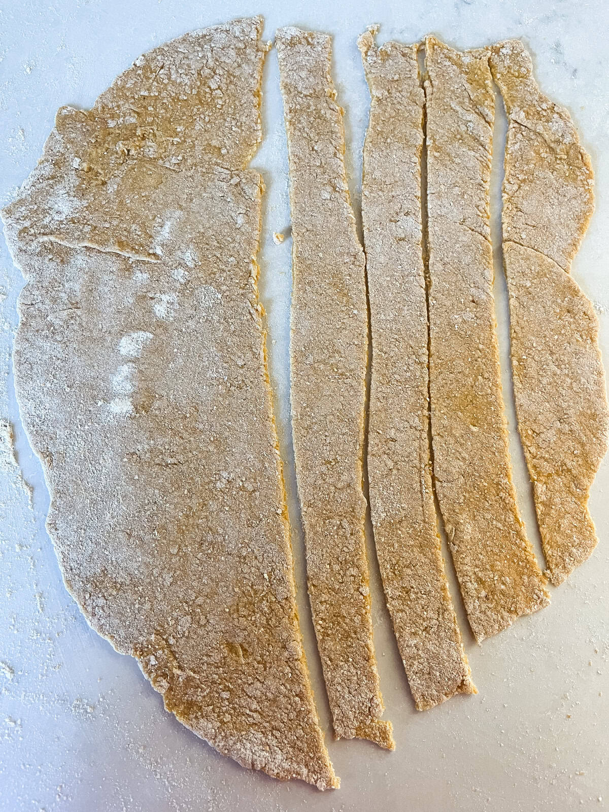 Dough rolled flat and cut into strips.