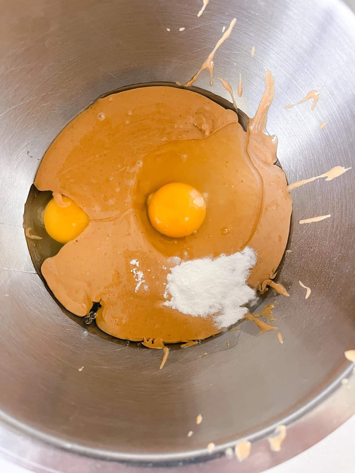 All of the peanut butter muffin ingredients in a mixing bowl.