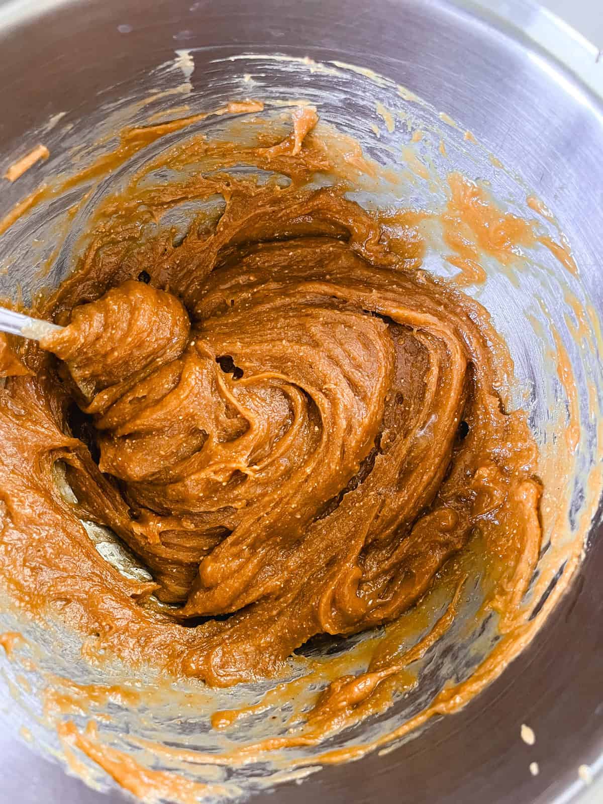 Stirring peanut butter muffin batter.