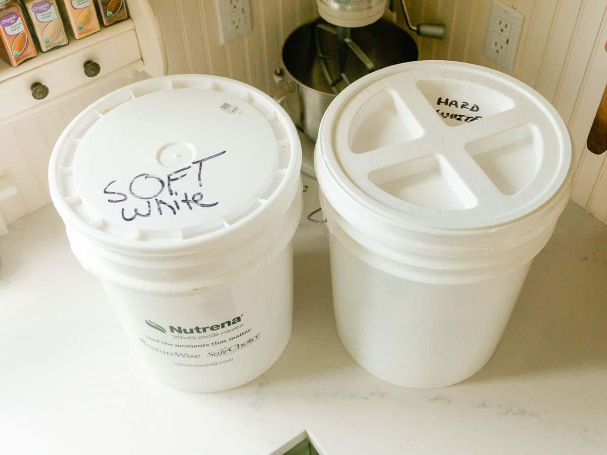 White 5-gallon food-grade buckets for storing whole grains.