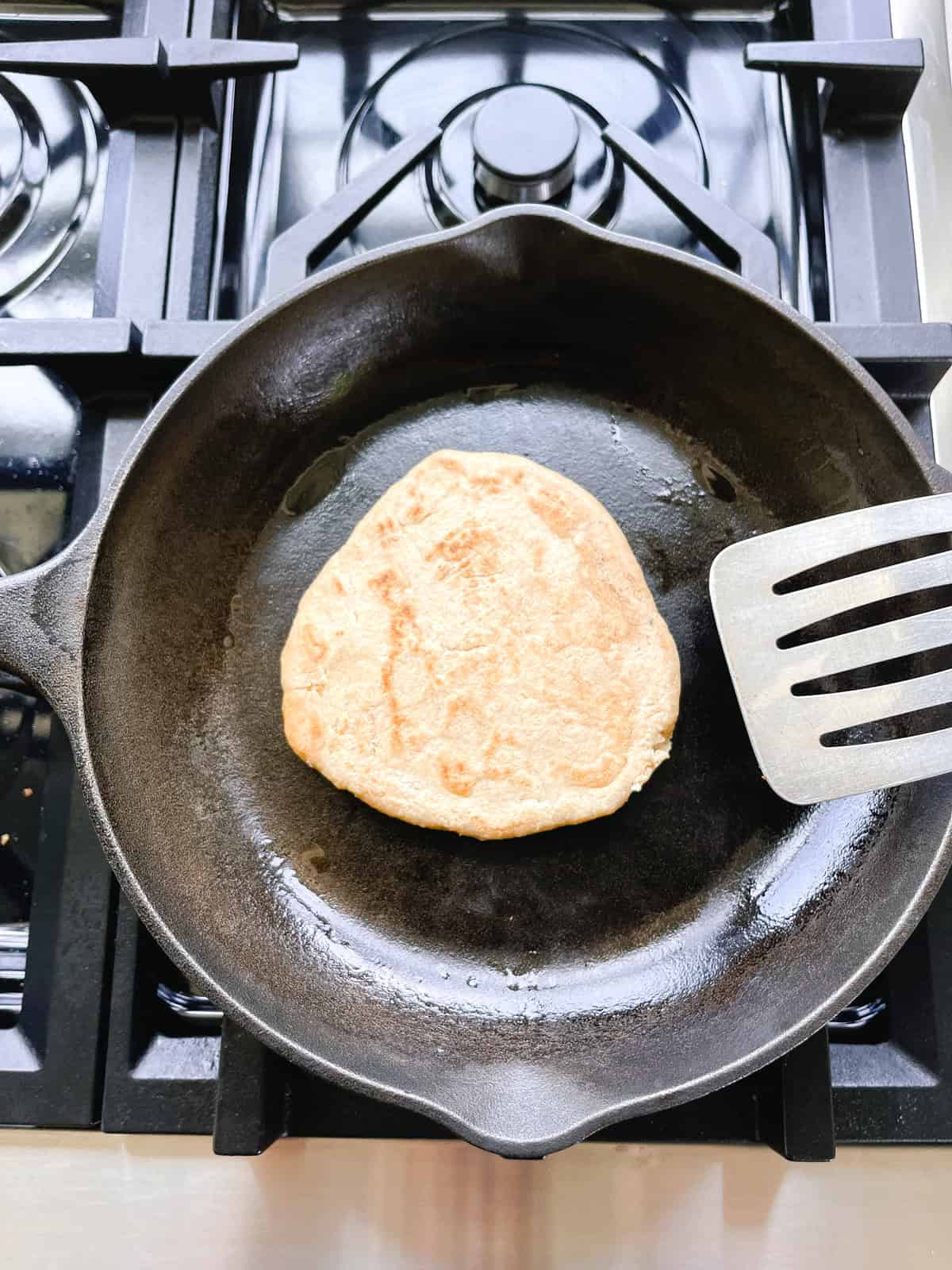 Frying freshly milled flatbread in a skillet.