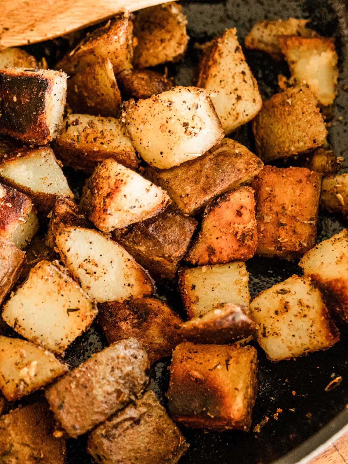 A close-up of crispy cast iron skillet potatoes.