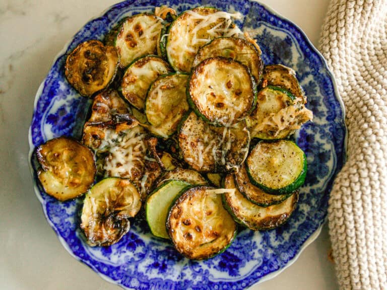 Cast iron skillet zucchini on a blue plate.
