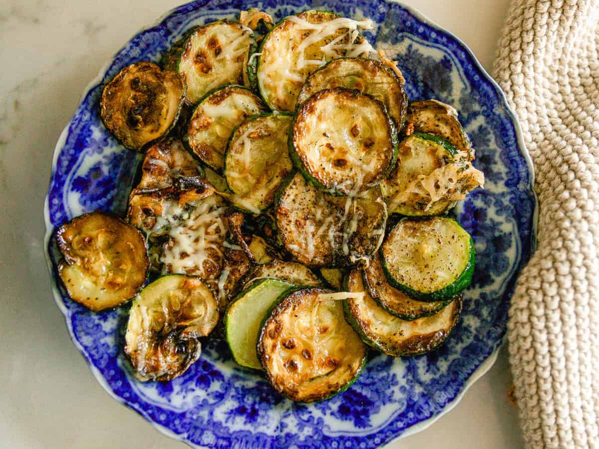 Cast iron skillet zucchini on a blue plate.