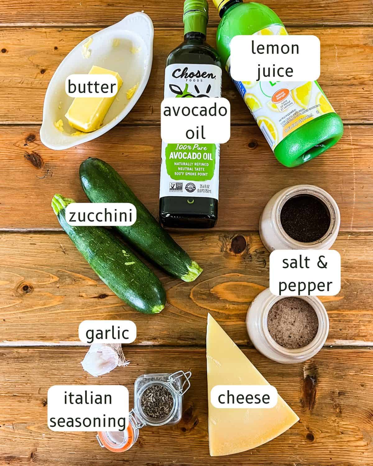 Cast iron skillet zucchini ingredients labeled on a wooden table.