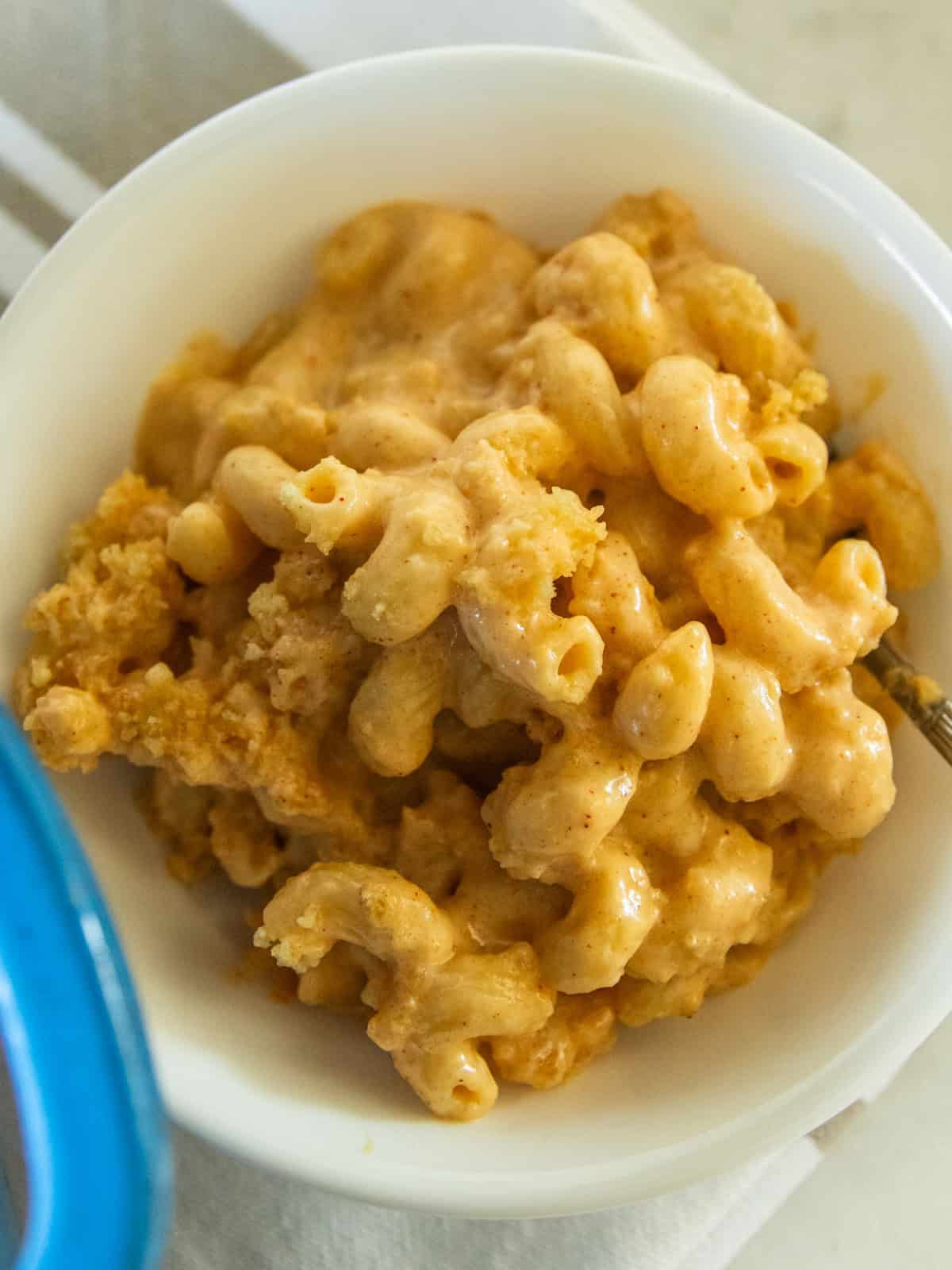 A white bowl with a serving of Dutch oven mac and cheese.