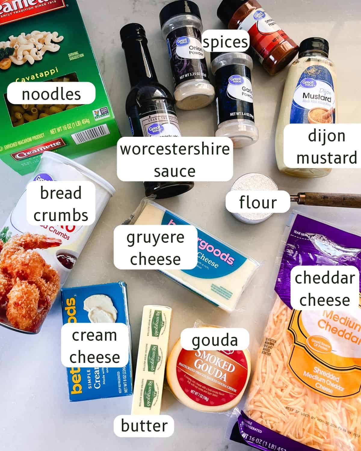 Dutch oven mac and cheese ingredients labeled on a white countertop.
