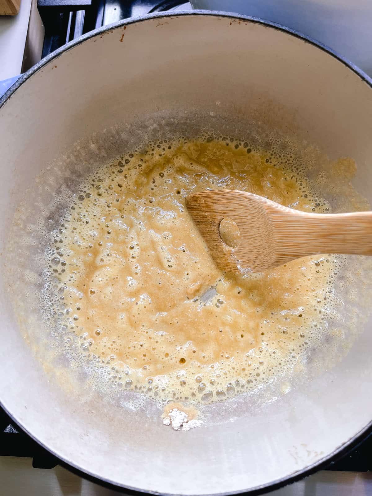 Stiring flour and butter in a dutch oven.