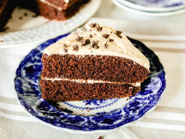 A slice of freshly milled chocolate cake on a blue plate.