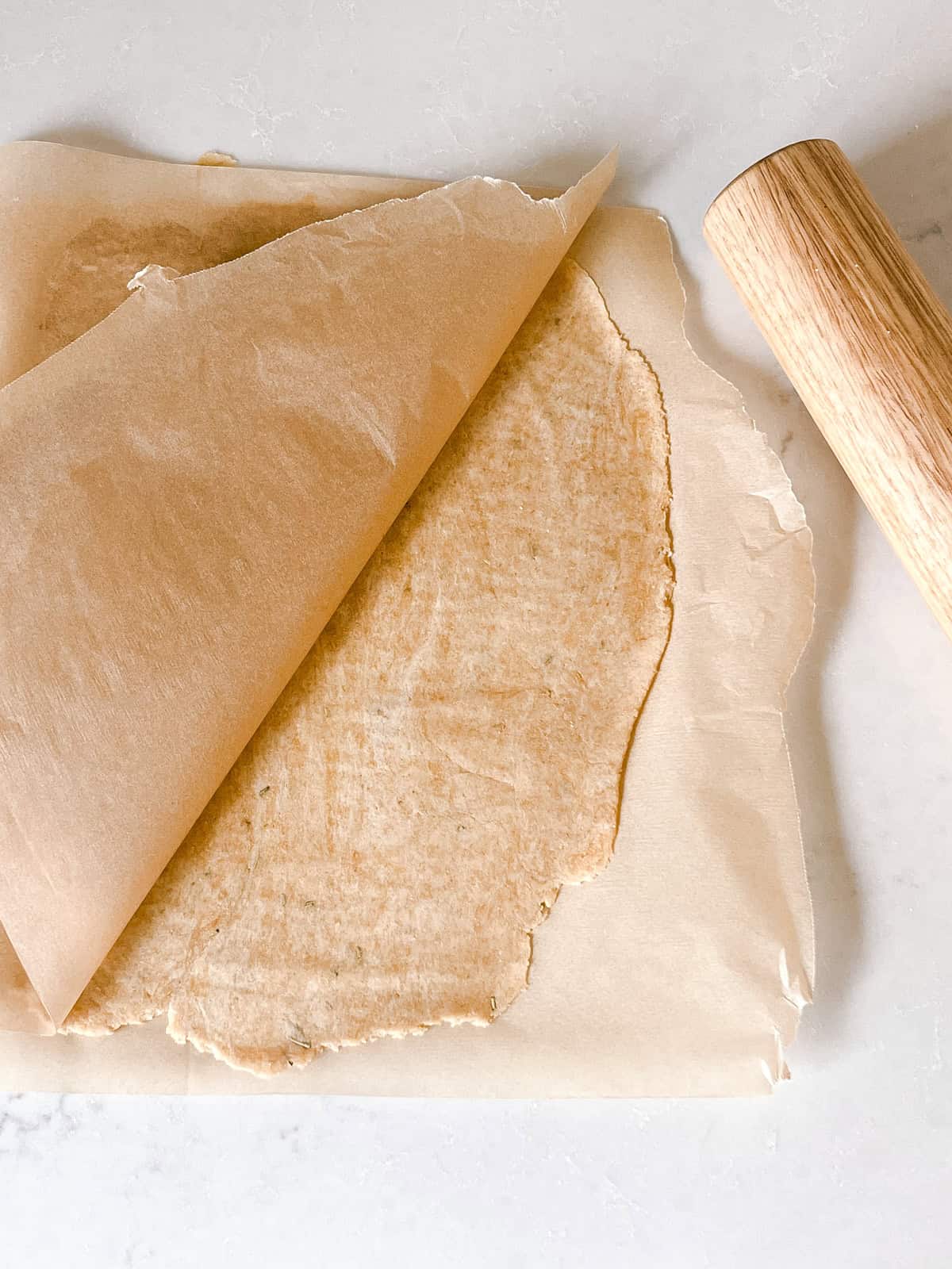 Fresh milled flour cracker dough rolled into a flat sheet.