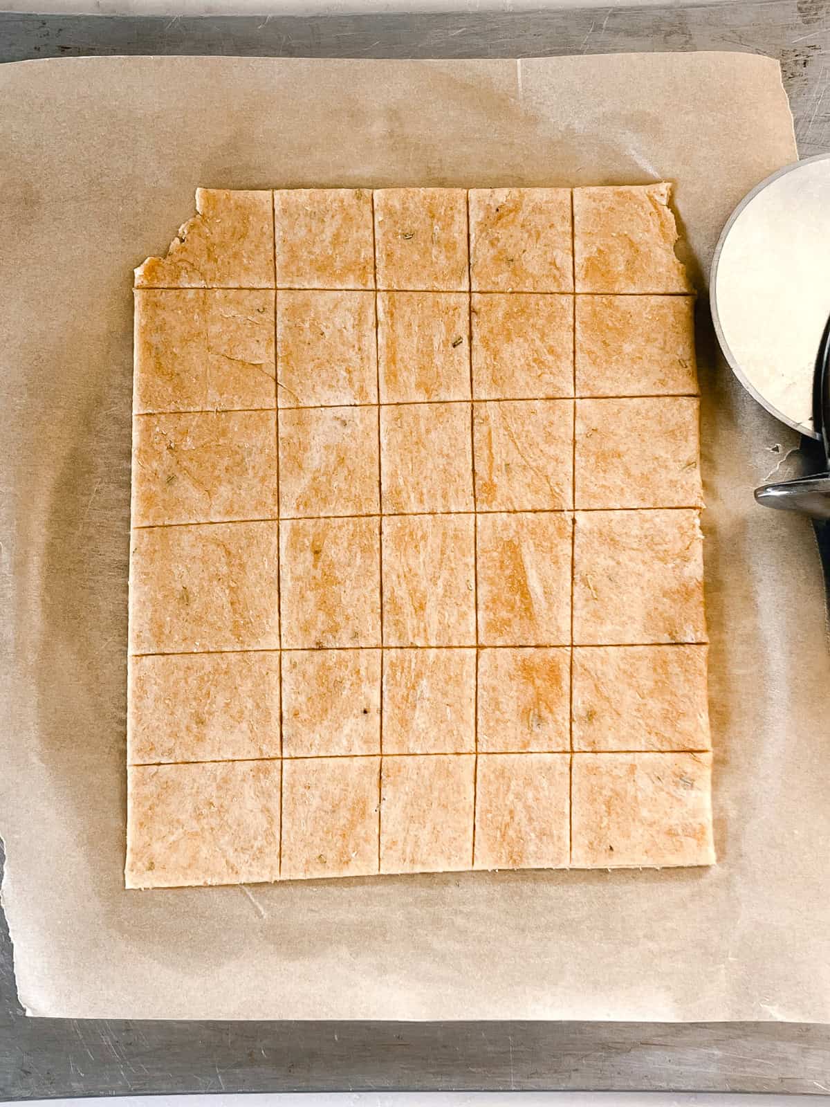 Fresh milled flour cracker dough cut into square pieces.