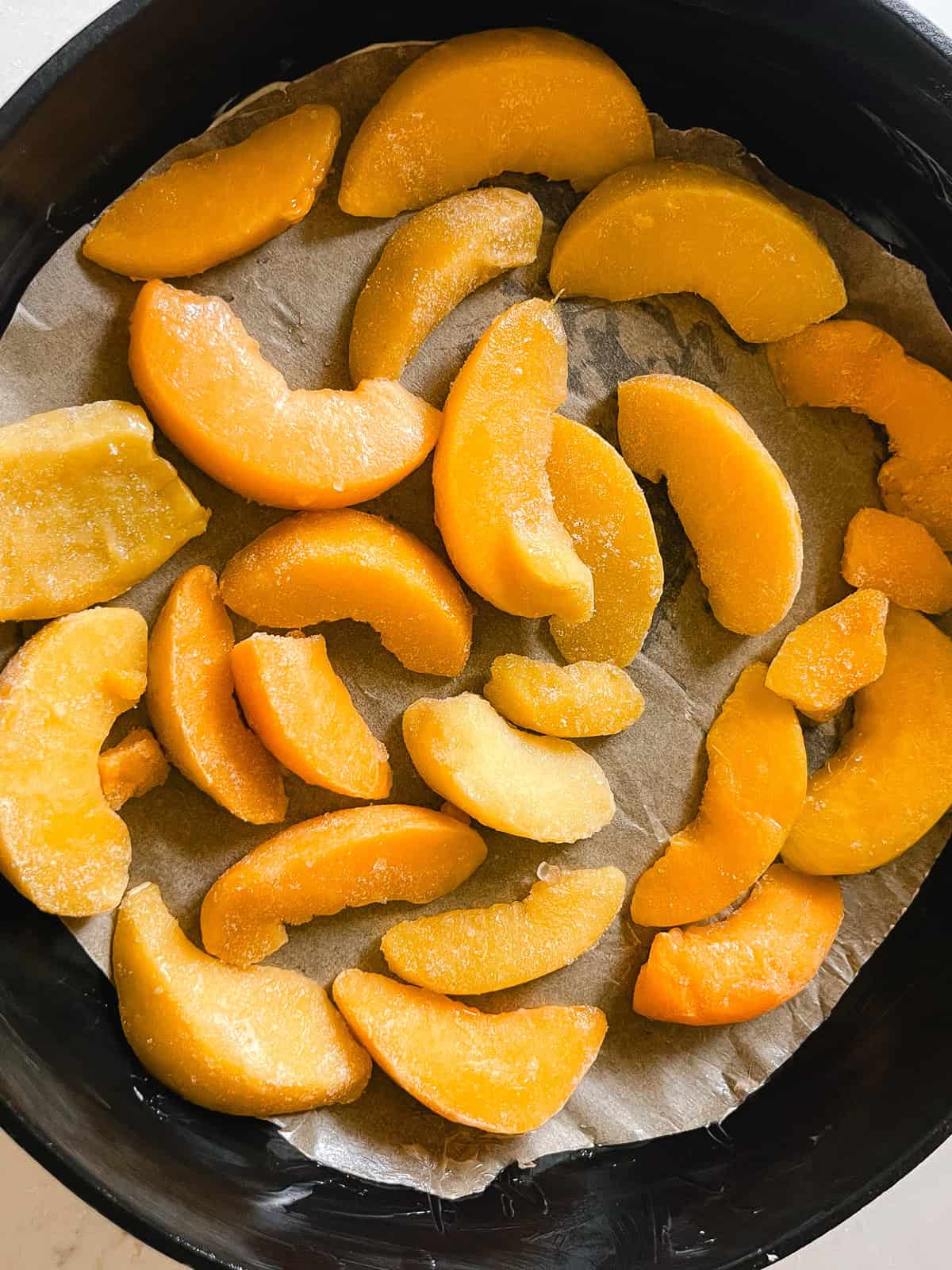 Peaches= slices spread out in the bottom of a cast iron skillet.