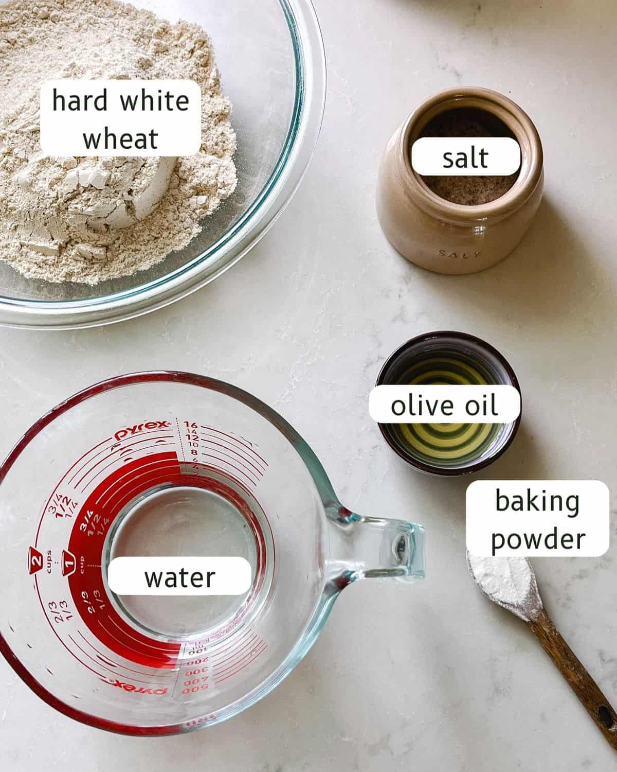 Freshly milled flatbread ingredients labeled on a kitchen counter.