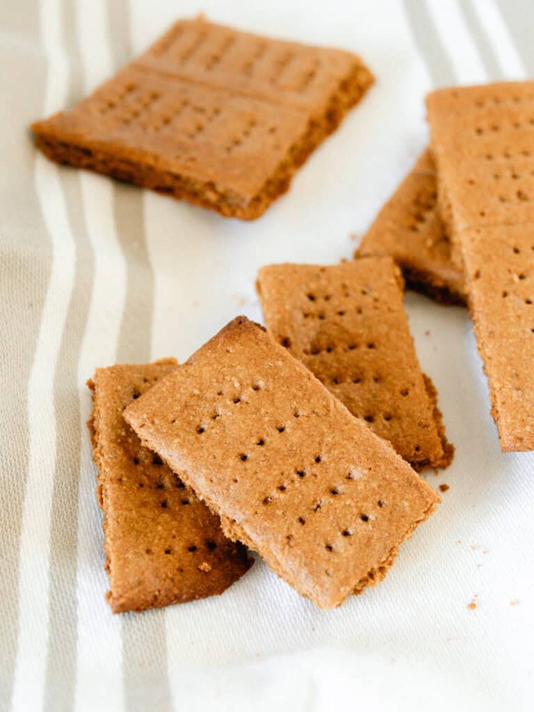 A stack of whole wheat graham crackers on a striped towel.