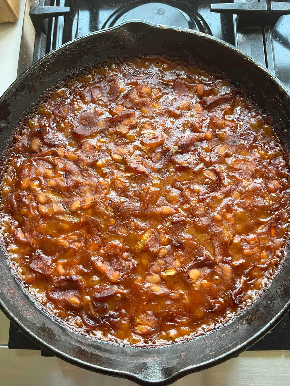 Baked beans in a cast iron skillet.
