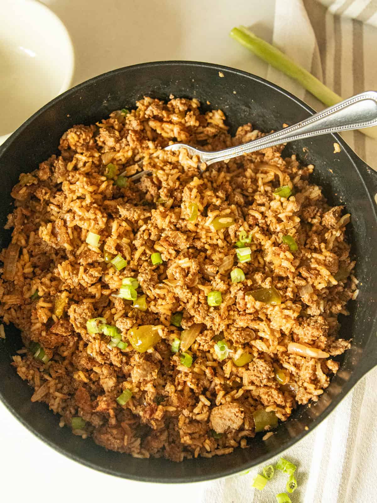 Cajun sausage and rice skillet with a fork.