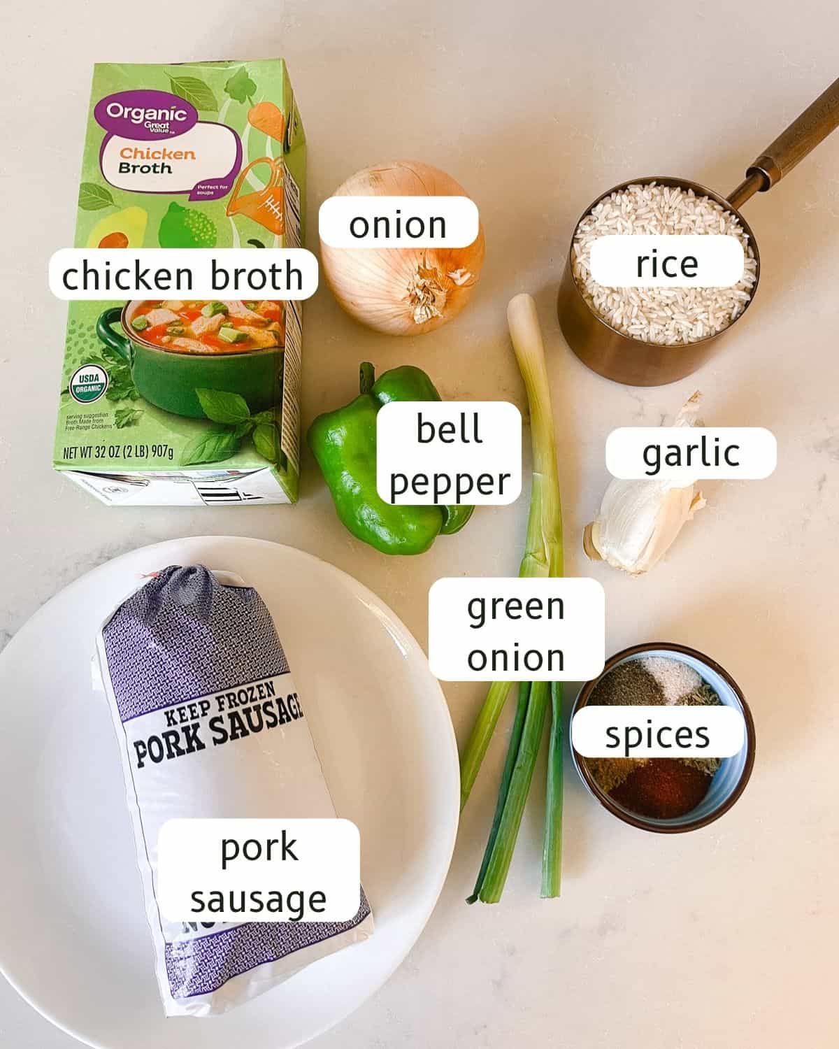 Cajun sausage and rice ingredients labeled on a kitchen countertop.