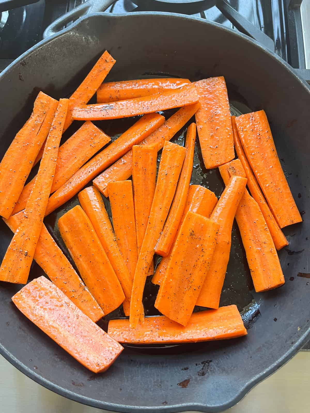 Cooking carrots in a cast iron skillet.