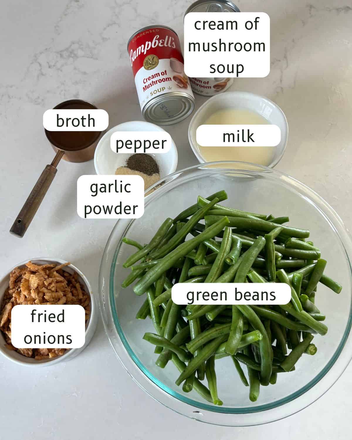 Dutch oven green bean casserole ingredients labeled on a countertop.