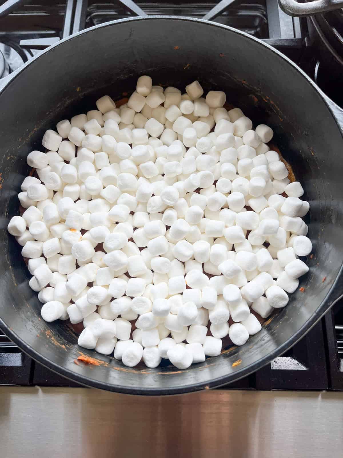 Sweet potato casserole topped with uncooked marshmallows.