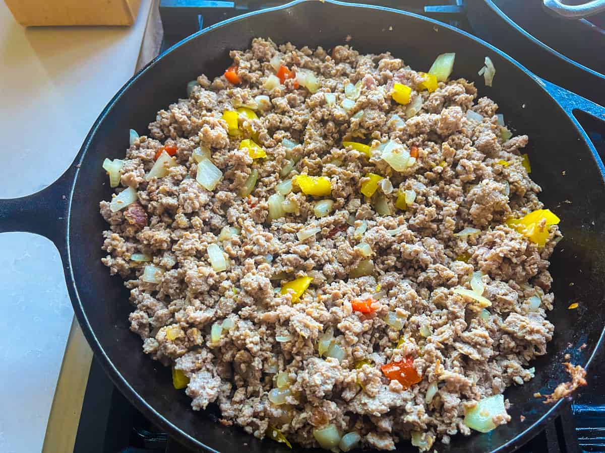 Cooked sausage with peppers and onions.