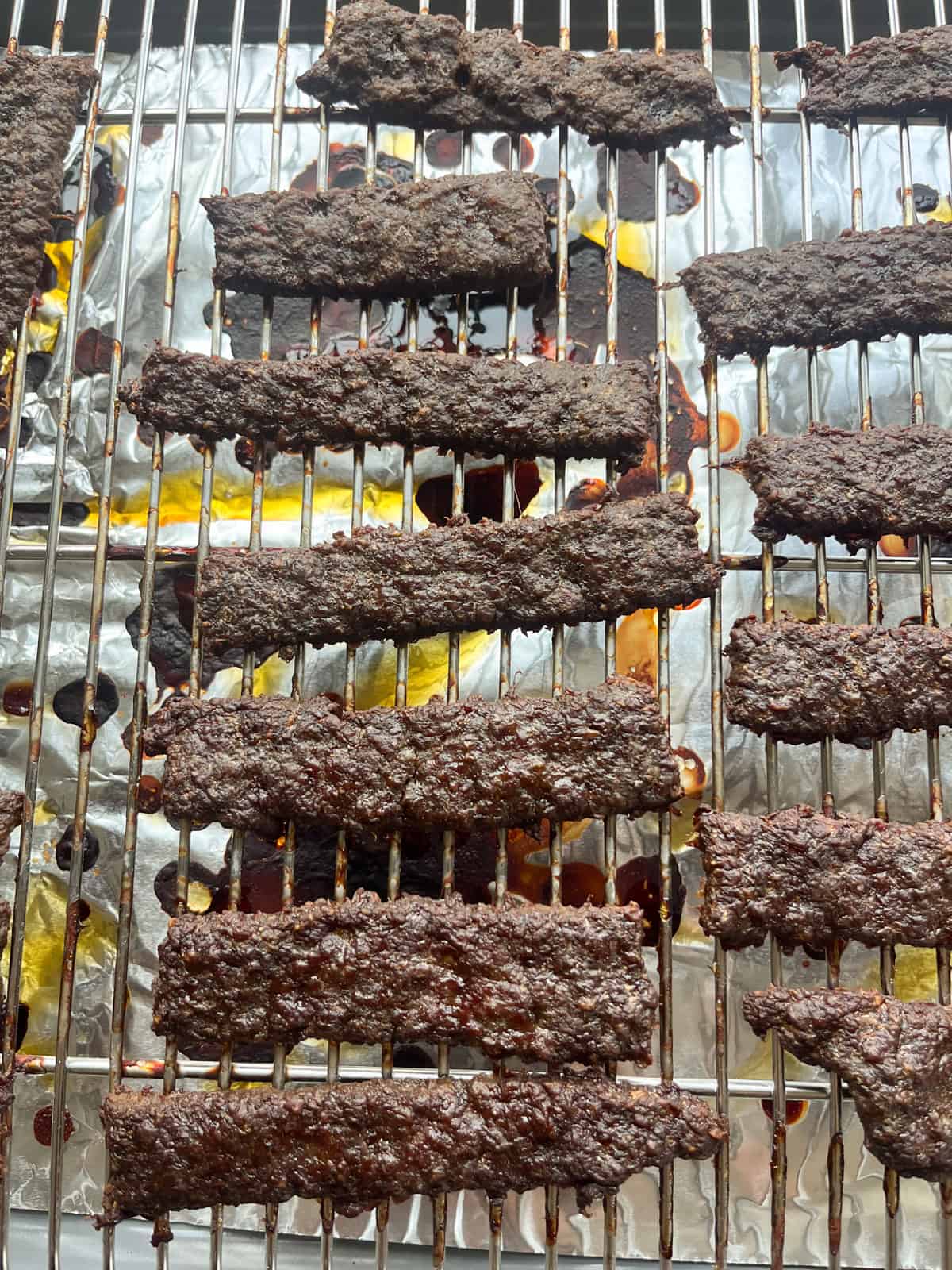Ground venison jerky on a wire rack.