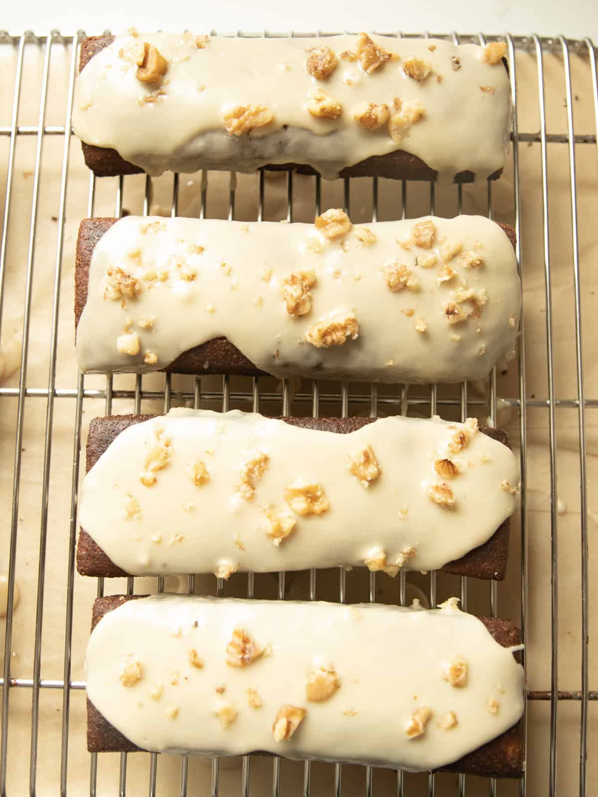 Maple bars lined up on a cooling wrack.