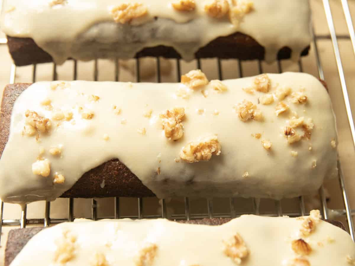 Maple bars with white glaze and walnuts on top.