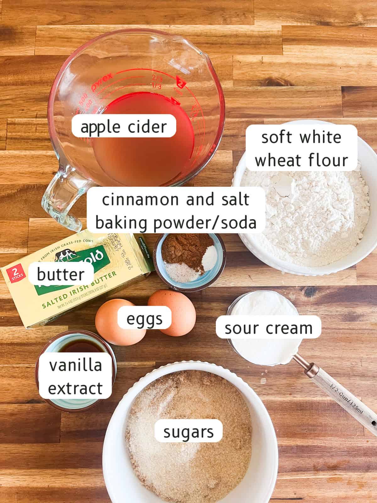Apple cider donuts ingredients labeled on a butcher block.