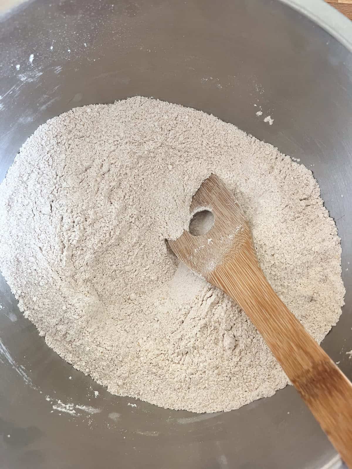Stirring dry ingredients in a mixing bowl.