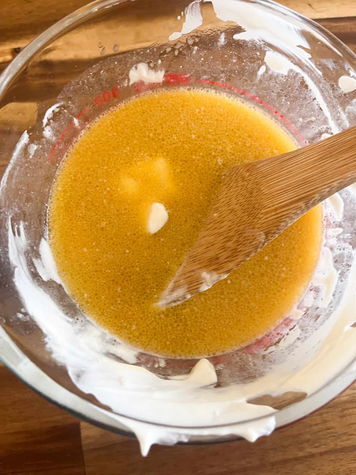 Mixing wet ingredients in a measuring cup.