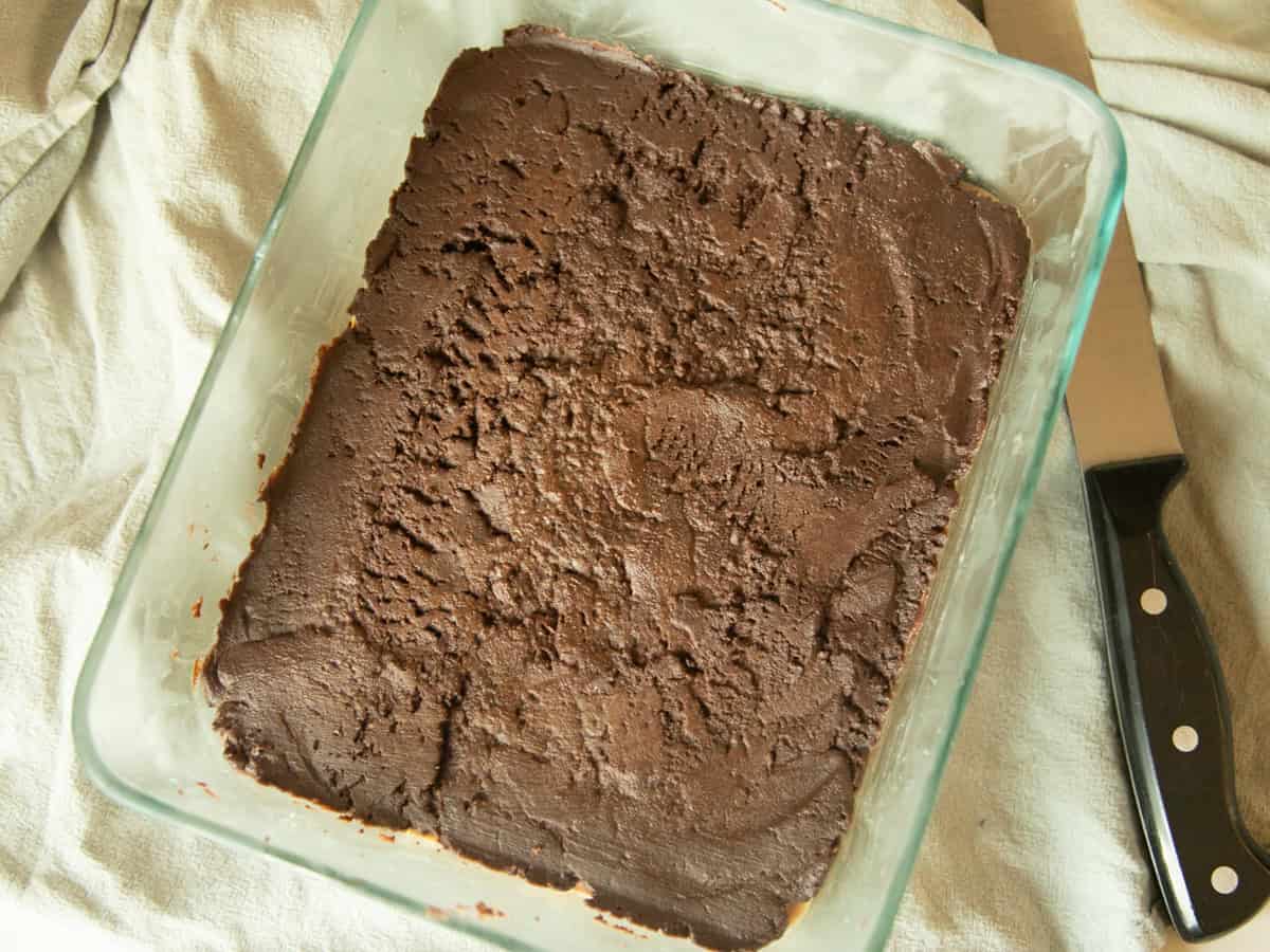 A baking dish of chocolate peanut butter bars before cutting.