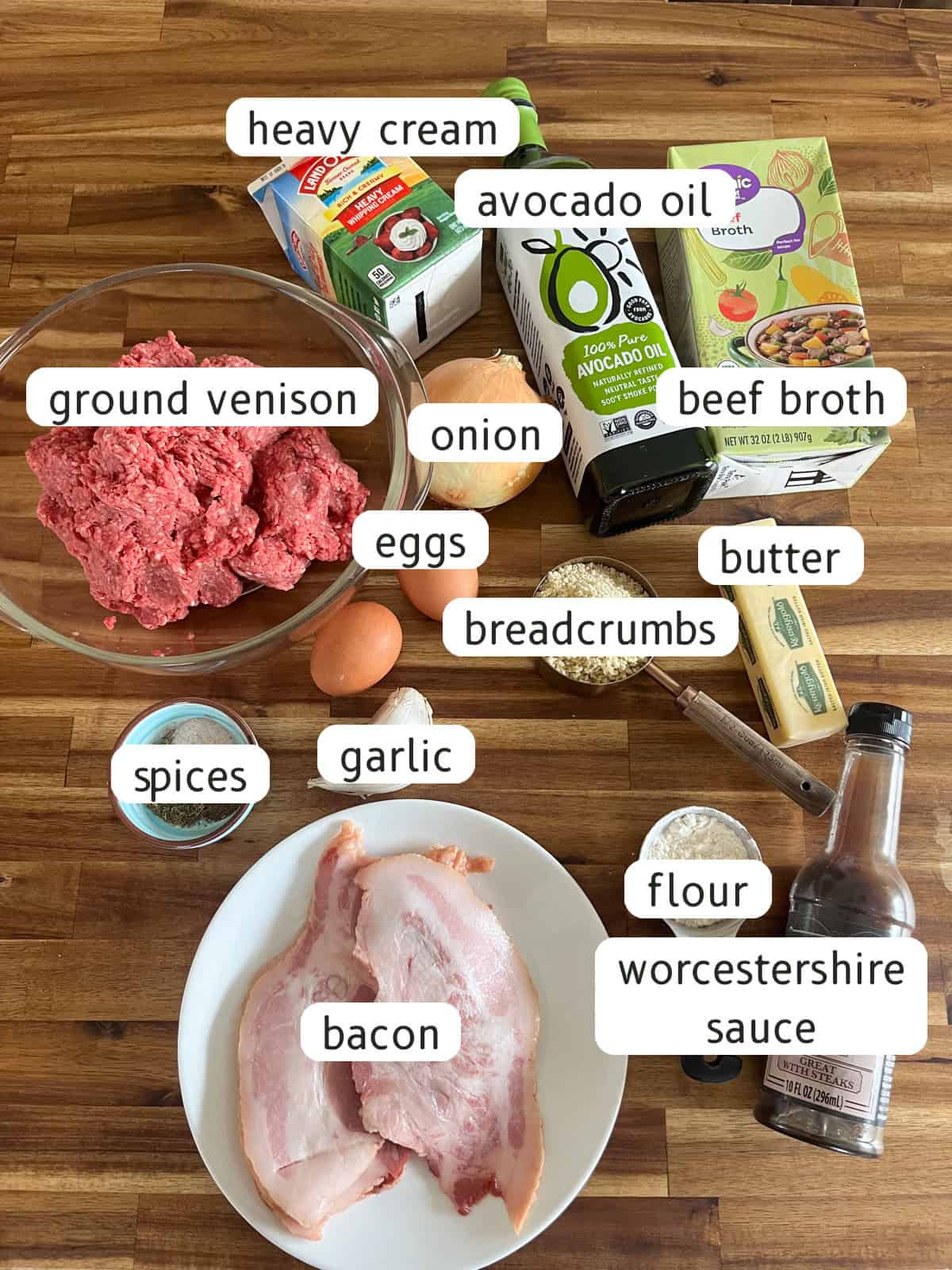 Venison meatballs ingredients on a wooden backdrop.