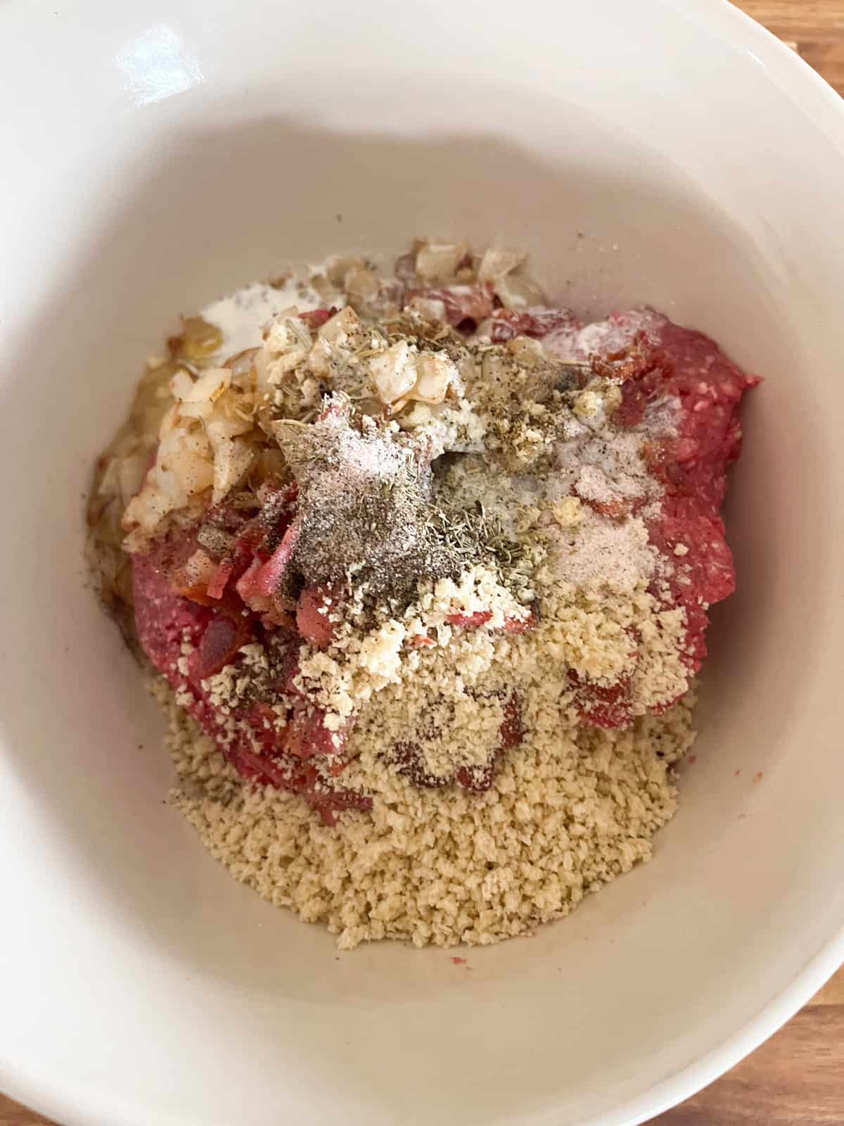 Venison meatball ingredients in a mixing bowl.