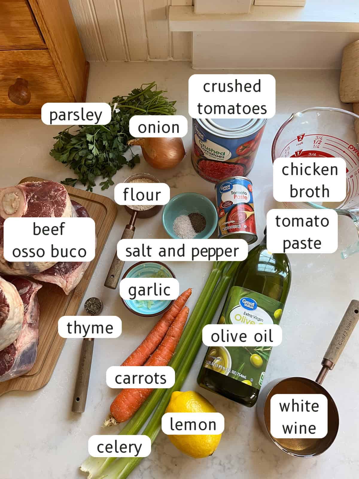 Beef osso buco ingredients labeled on a kitchen counter.