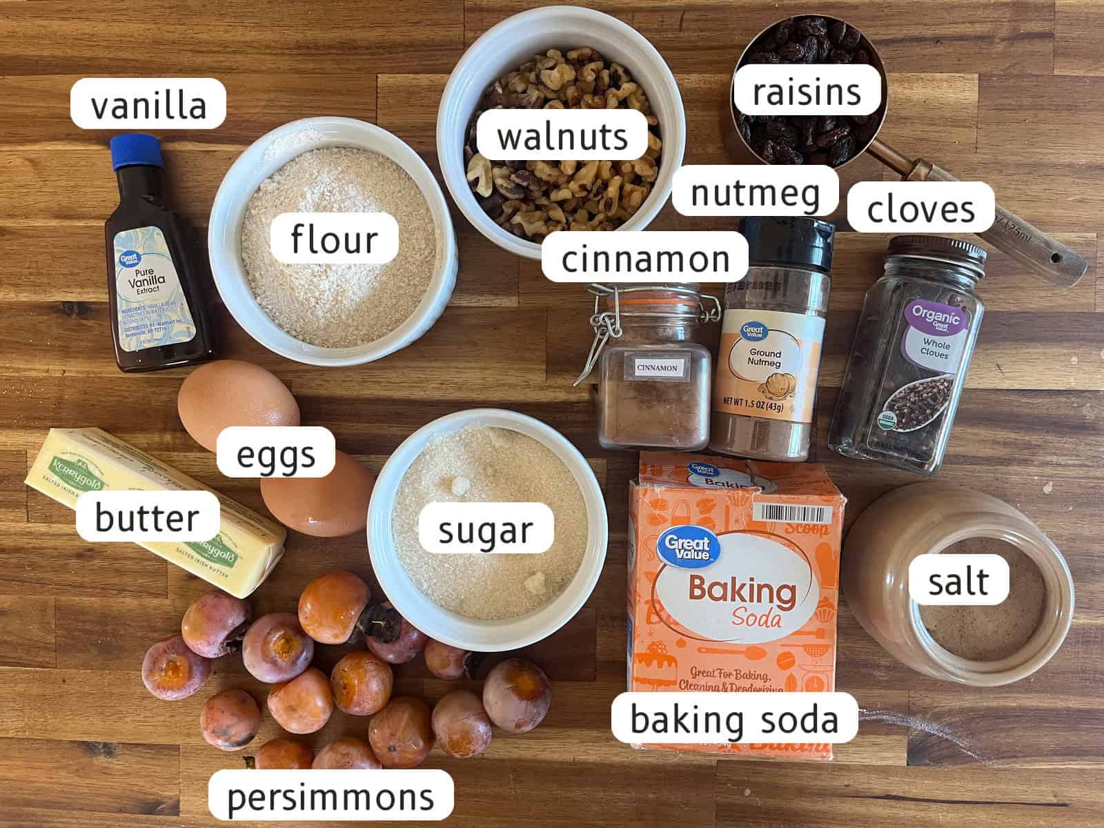 Persimmon bread ingredients labeled on a butcher block.