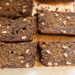 Slices of persimmon bread lined up on a wooden board.