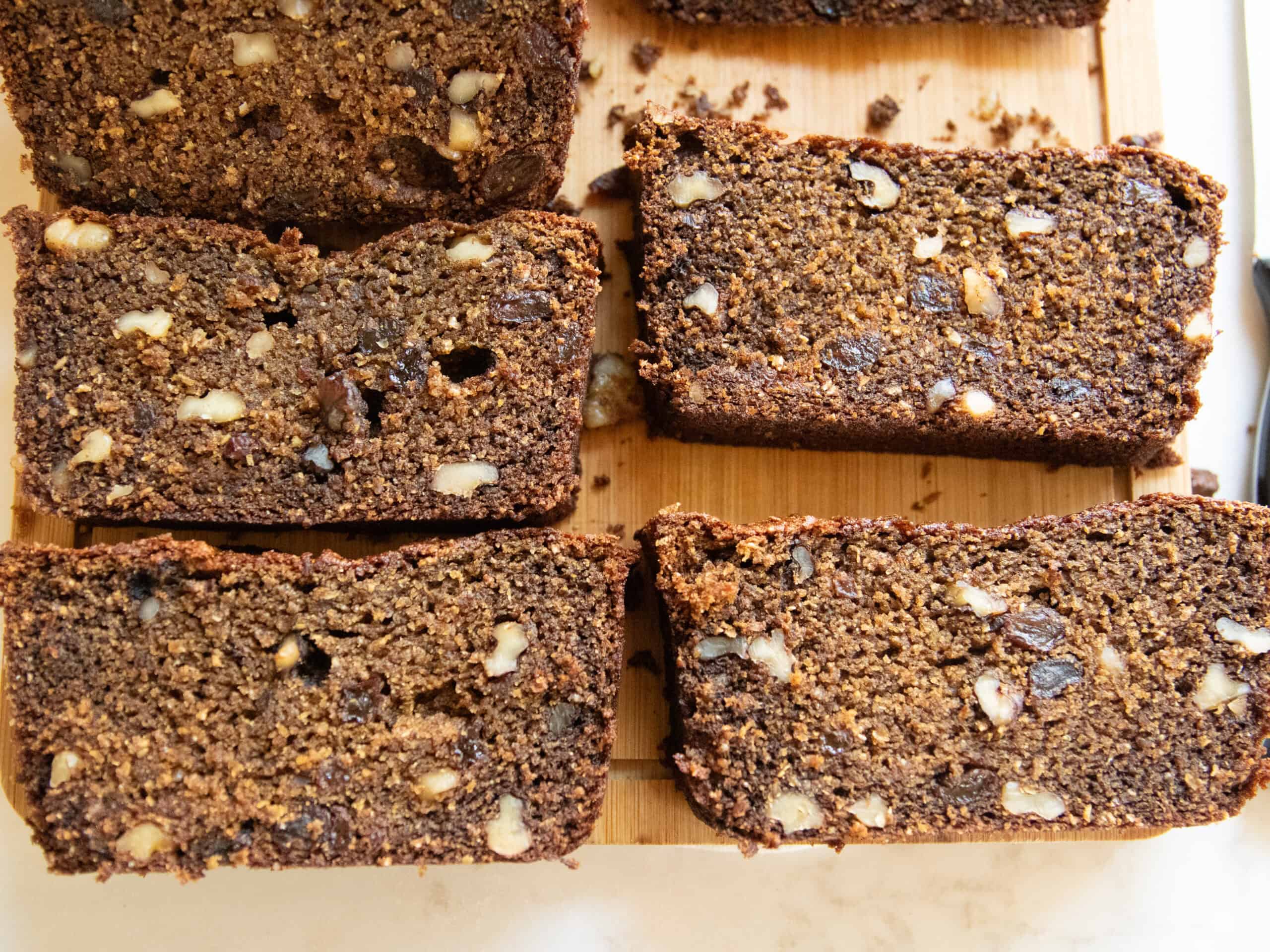 Slices of persimmon bread lined up on a wooden board.