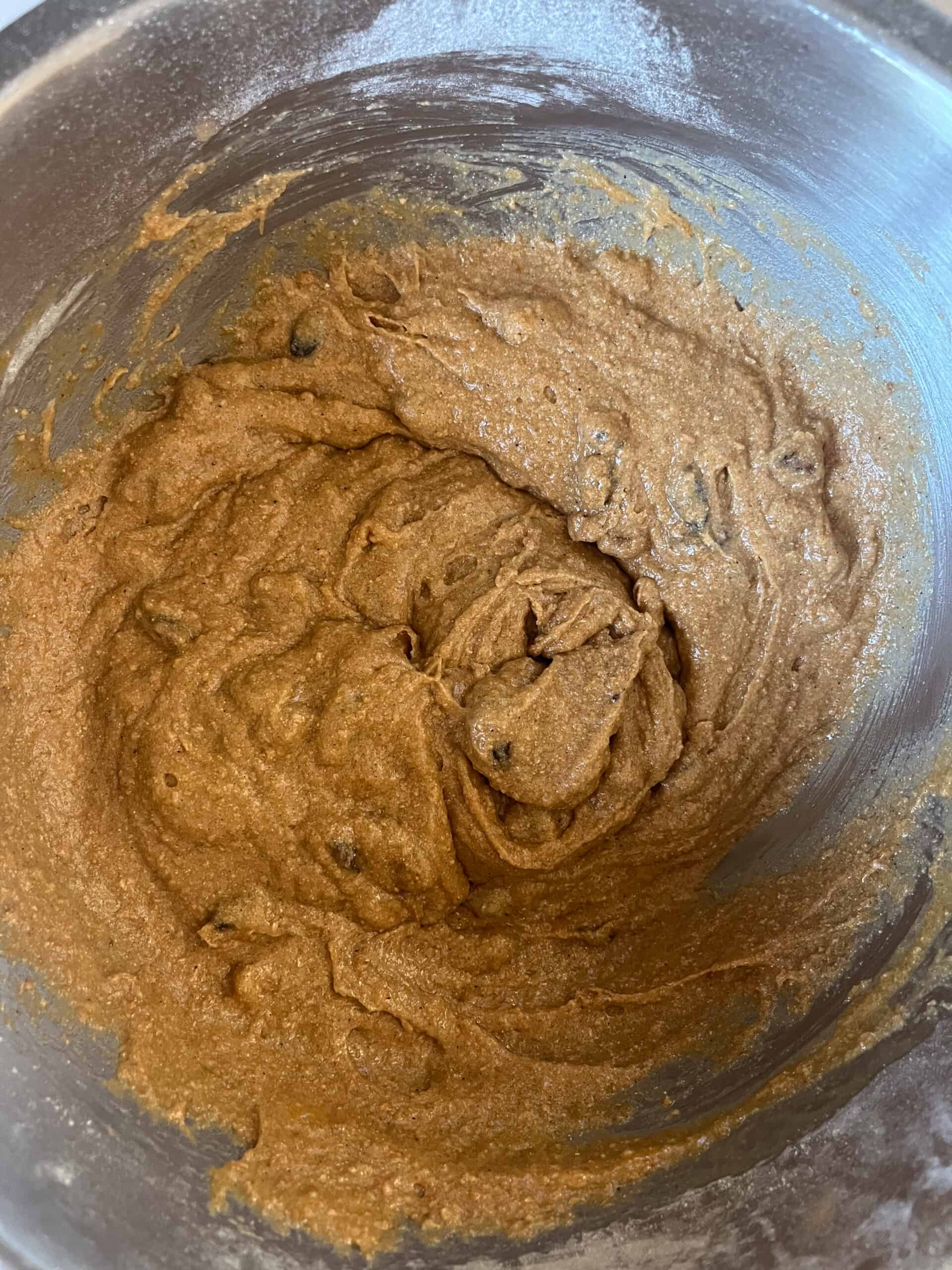 Mixing persimmon bread batter in a mixing bowl.