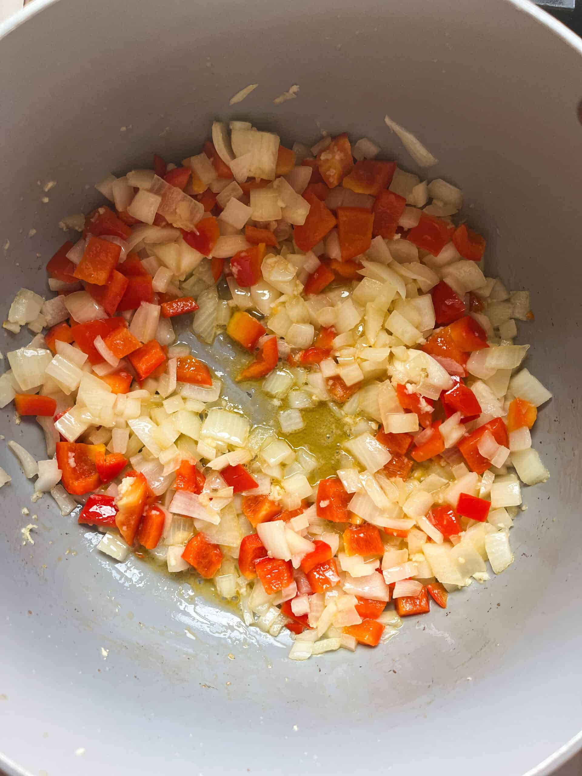 Sauteing onions and peppers in a dutch oven.